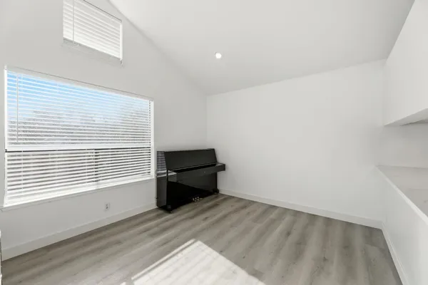 a room with a window and a wooden floor