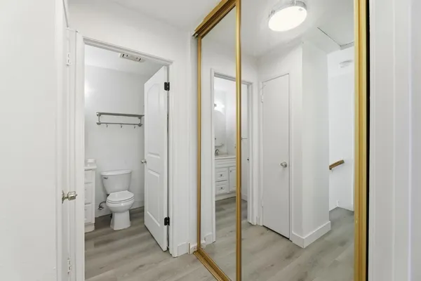 a bathroom view of a toilet and a glass door