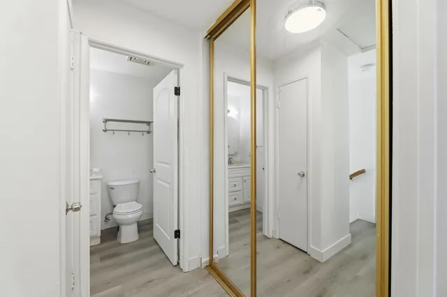 a bathroom view of a toilet and a glass door