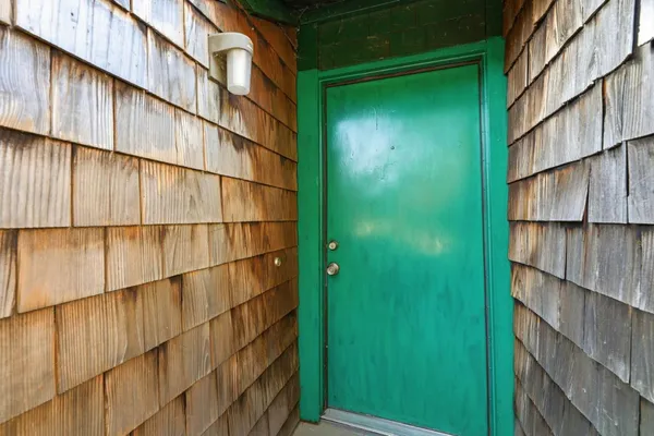 a view of a wooden door and brick wall