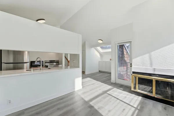 a kitchen with stainless steel appliances granite countertop a sink and a stove top oven