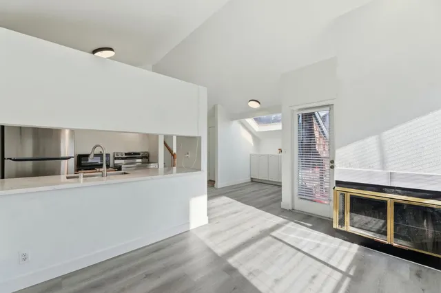 a kitchen with stainless steel appliances granite countertop a sink and a stove top oven