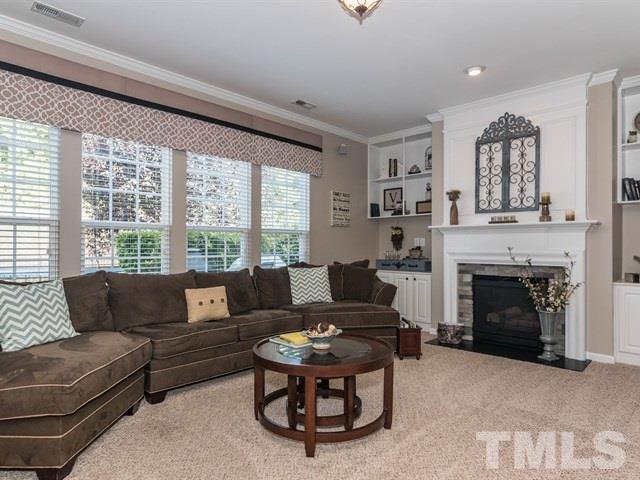 3319 Cathedral Bell Road Raleigh, NC 27614 - Photo 13 of 25 Stacked stone gas log fireplace is flanked by built-ins.