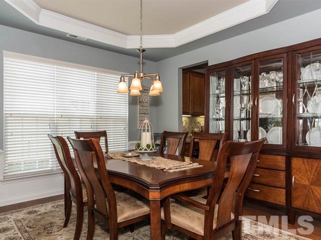 3319 Cathedral Bell Road Raleigh, NC 27614 - Photo 6 of 25 Elegant dining room detailed with moulding, wainscoting and tray ceiling.