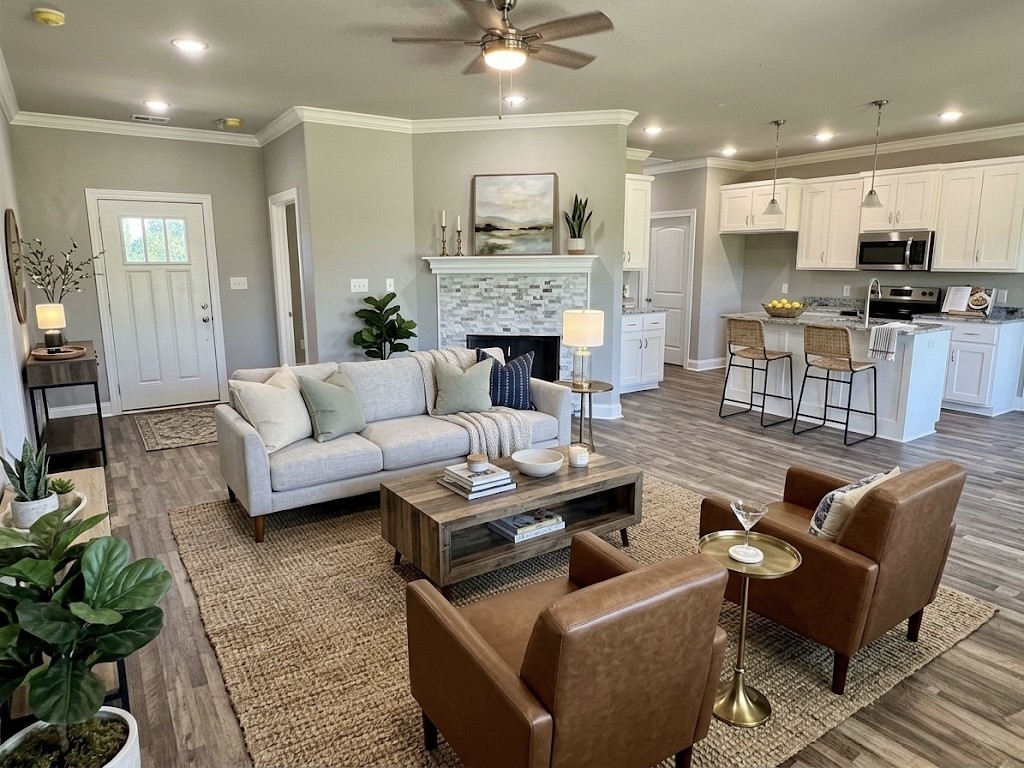 8369 State Line Road Taft, TN 38488 - Photo 11 of 25 a living room with furniture a fireplace and a kitchen view