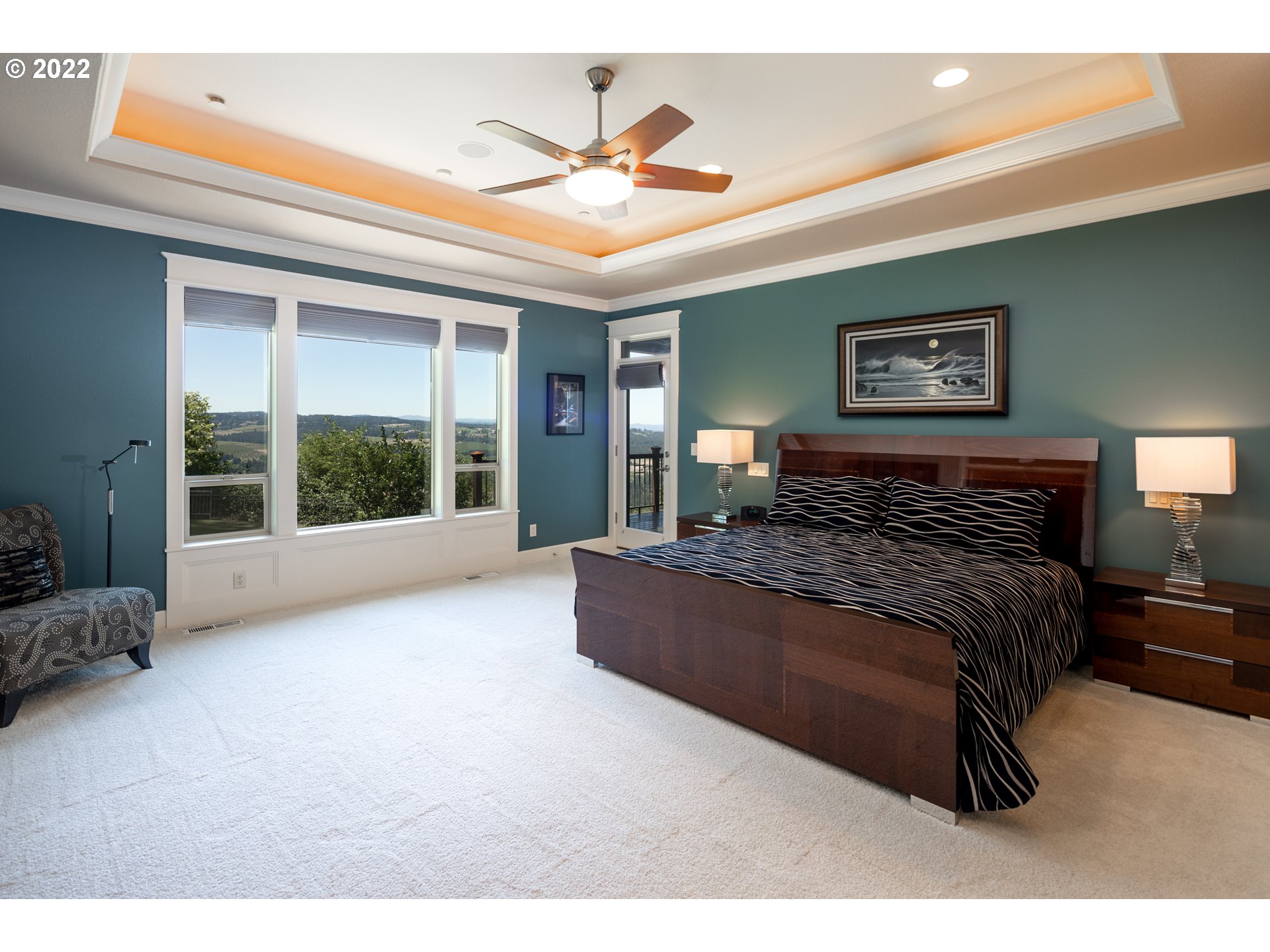 26997 Southwest Labrousse Road Sherwood, OR 97140 - Photo 17 of 32 a spacious bedroom with a large bed and a chandelier