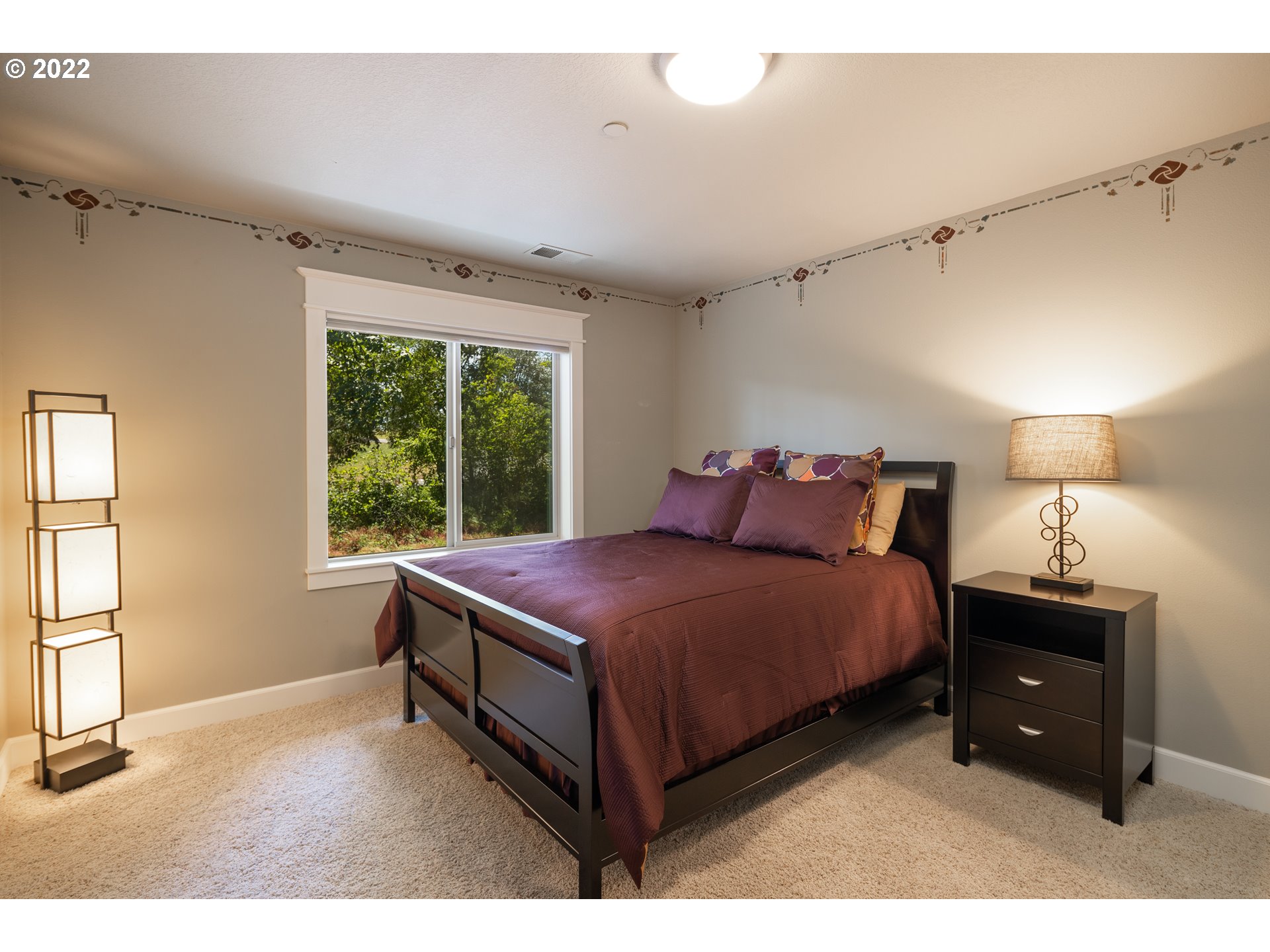 26997 Southwest Labrousse Road Sherwood, OR 97140 - Photo 22 of 32 a spacious bedroom with a bed and a window