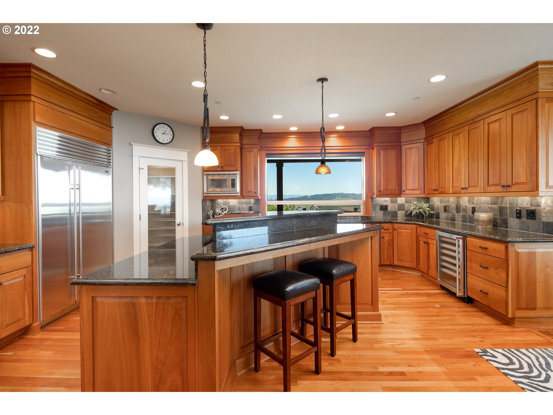 26997 Southwest Labrousse Road Sherwood, OR 97140 - Photo 8 of 32 a kitchen with stainless steel appliances granite countertop wooden cabinets a stove a sink and a refrigerator