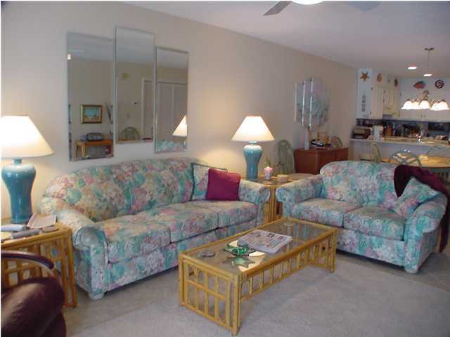 6015 Highway Santa Rosa Beach, Unit A101 30A Santa Rosa Beach, FL 32459 - Photo 2 of 18 a living room with furniture and a lamp