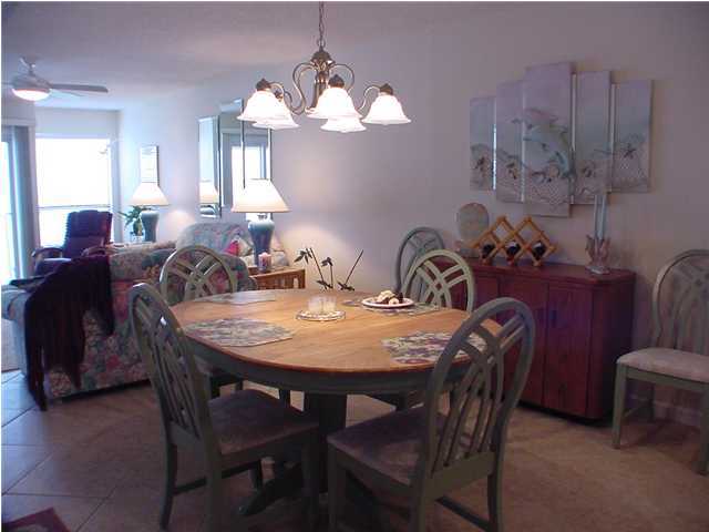 6015 Highway Santa Rosa Beach, Unit A101 30A Santa Rosa Beach, FL 32459 - Photo 11 of 18 a view of a dining room with furniture and chandelier
