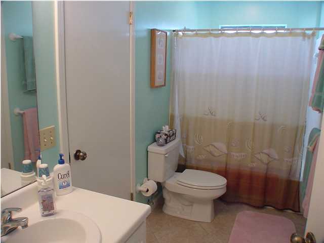 6015 Highway Santa Rosa Beach, Unit A101 30A Santa Rosa Beach, FL 32459 - Photo 8 of 18 a bathroom with a toilet a sink and shower