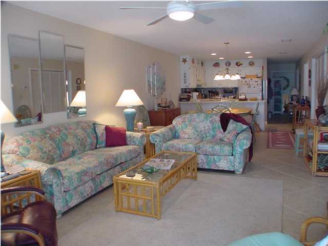 6015 Highway Santa Rosa Beach, Unit A101 30A Santa Rosa Beach, FL 32459 - Photo 9 of 18 a living room with furniture and a chandelier