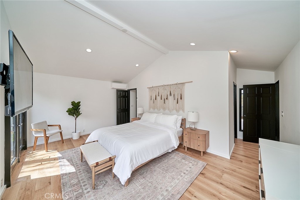 8457 Ridpath Drive Los Angeles, CA 90046 - Photo 11 of 33 a bedroom with a bed and a table