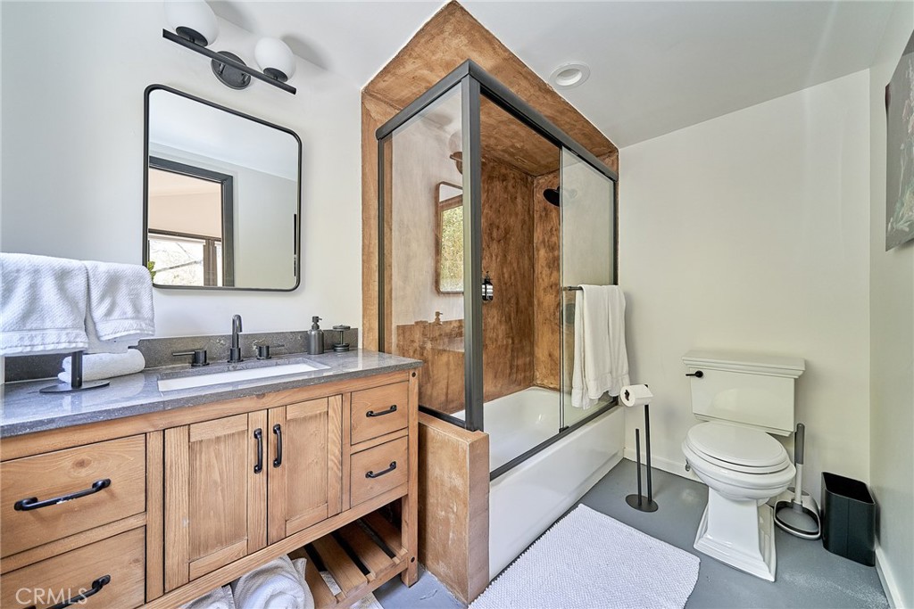 8457 Ridpath Drive Los Angeles, CA 90046 - Photo 13 of 33 a spacious bathroom with a double vanity sink toilet mirror and bathtub