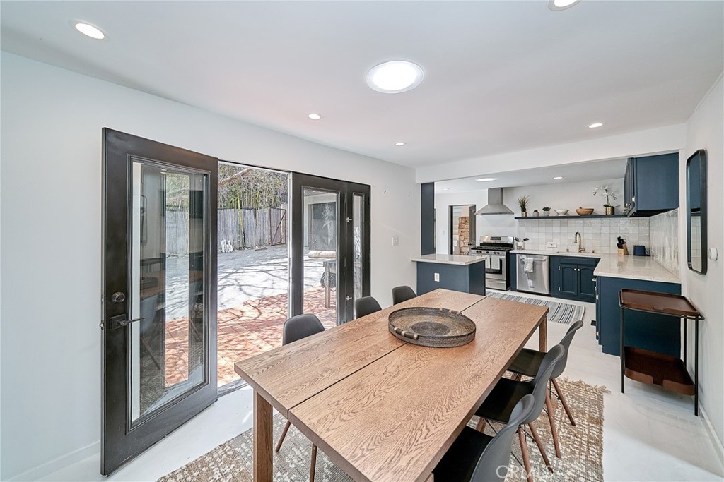 8457 Ridpath Drive Los Angeles, CA 90046 - Photo 15 of 33 a view of a dining room with furniture and a window
