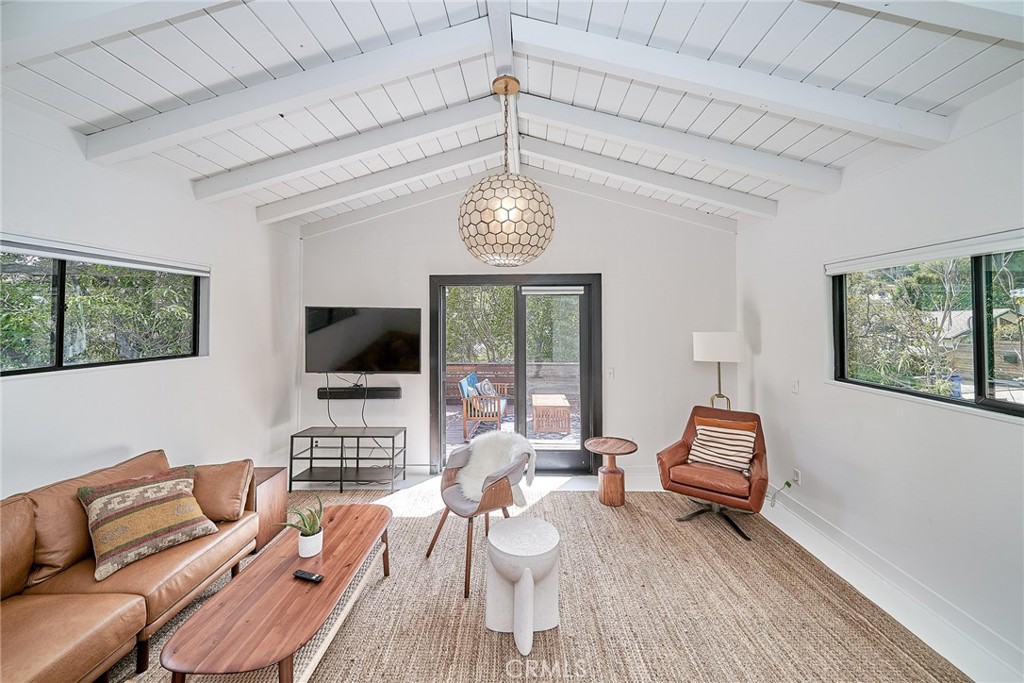 8457 Ridpath Drive Los Angeles, CA 90046 - Photo 20 of 33 a living room with furniture a flat screen tv and a chandelier
