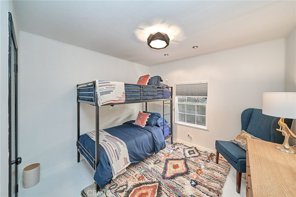 8457 Ridpath Drive Los Angeles, CA 90046 - Photo 3 of 33 a bedroom with furniture and a window