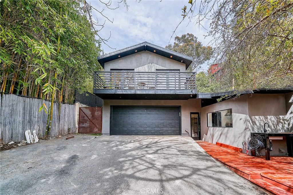 8457 Ridpath Drive Los Angeles, CA 90046 - Photo 32 of 33 a front view of a house with a yard and garage