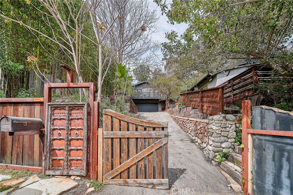 8457 Ridpath Drive Los Angeles, CA 90046 - Photo 33 of 33 front view of a house with large trees and wooden fence