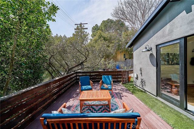 a view of a two chairs and table in the balcony