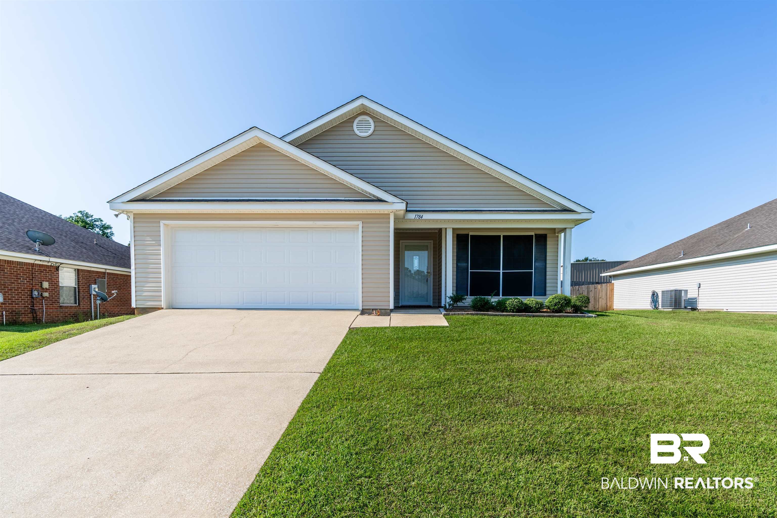 1784 Harrington Way Mobile, AL 36695 - Photo 1 of 18 View of front of property with a front yard, a garage, and central air condition unit
