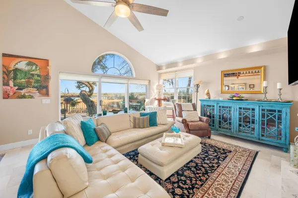 a kitchen with stainless steel appliances granite countertop a refrigerator a sink and white cabinets