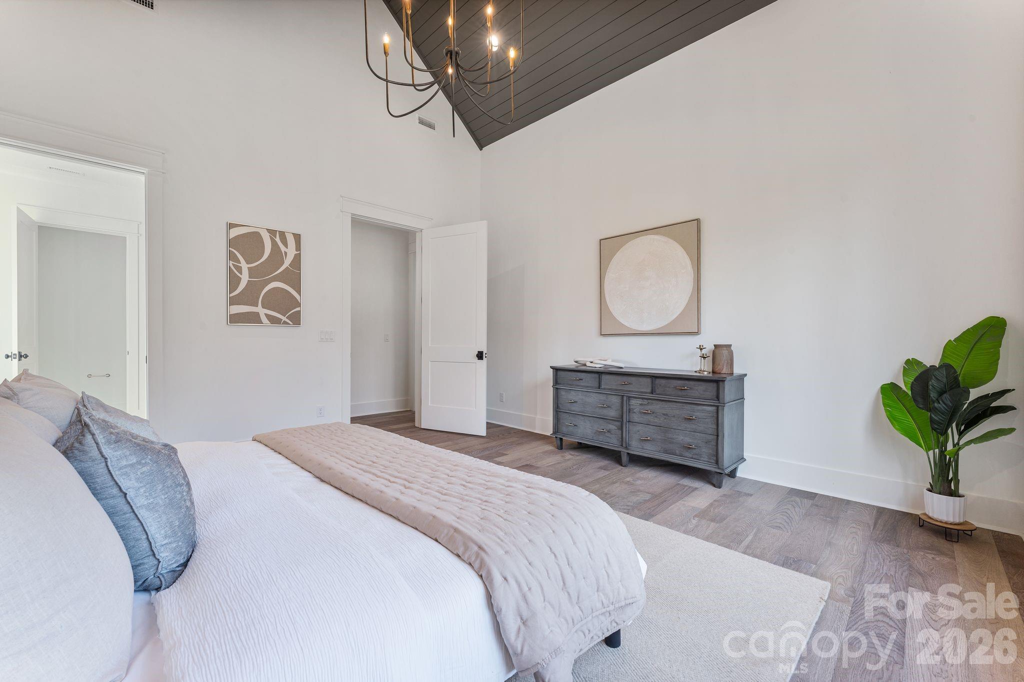 636 American Bittern Way Clover, SC 29710 - Photo 22 of 41 a bedroom with a bed and a chandelier