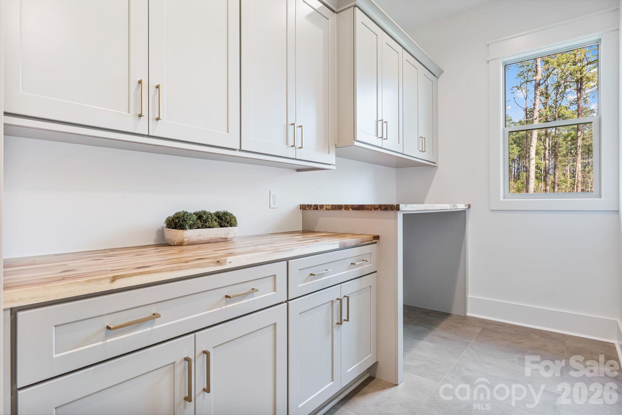 636 American Bittern Way Clover, SC 29710 - Photo 24 of 41 a kitchen with white cabinets and a window