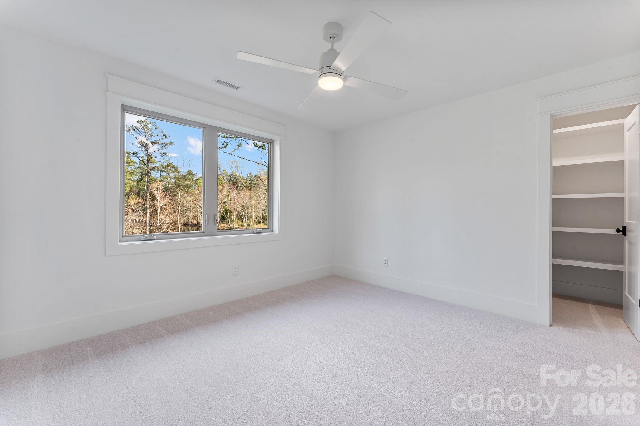 636 American Bittern Way Clover, SC 29710 - Photo 33 of 41 an empty room with windows and ceiling fan