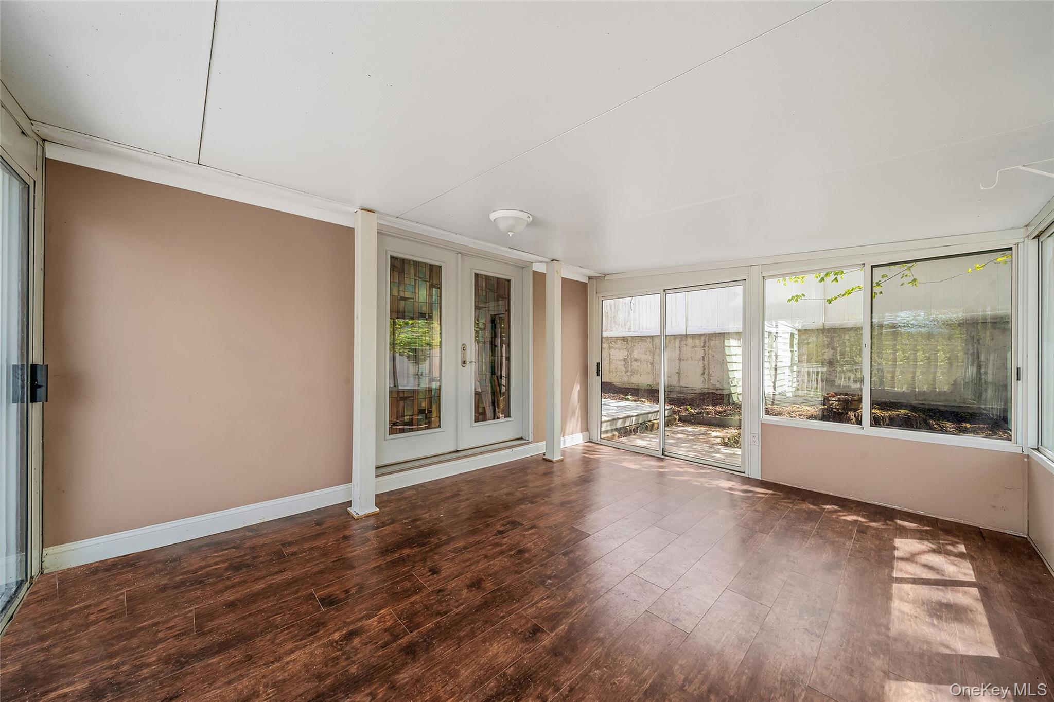 93 Maple Road Kings Park, NY 11754 - Photo 23 of 24 a view of an empty room with wooden floor and a window