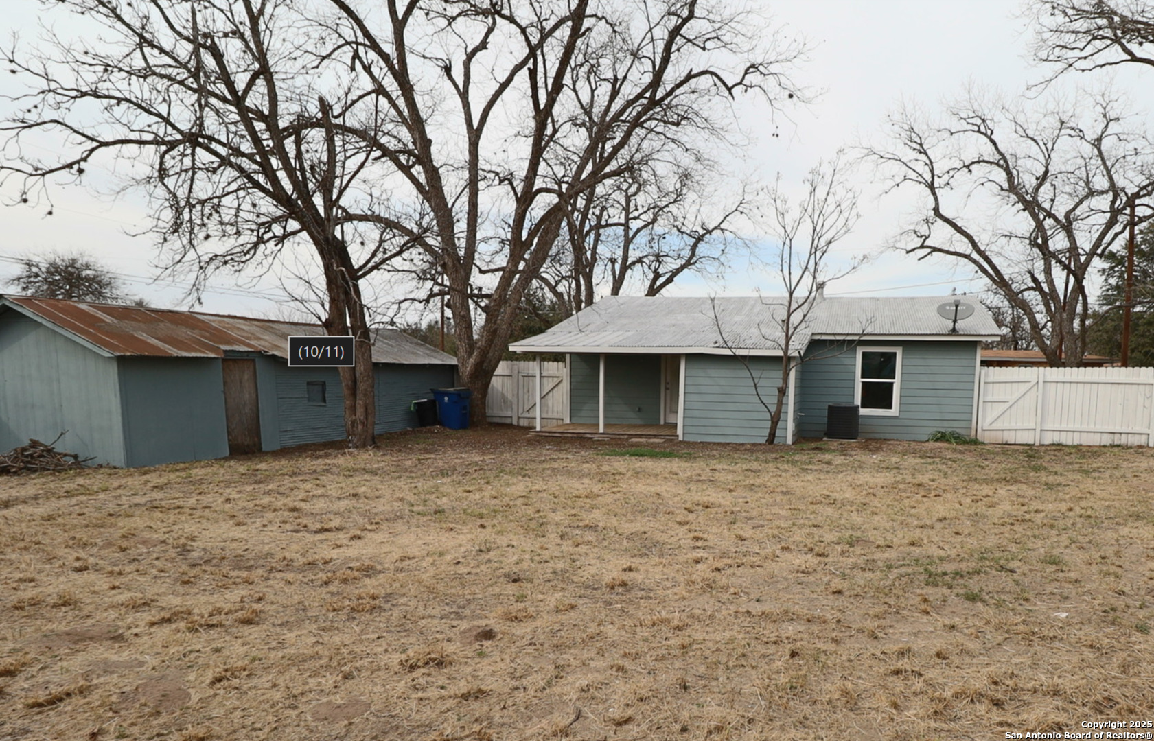 433 West Adams Street Pleasanton, TX 78064 - Photo 12 of 13 a house with trees in front of it