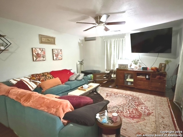 433 West Adams Street Pleasanton, TX 78064 - Photo 2 of 13 a living room with a couch and a flat screen tv