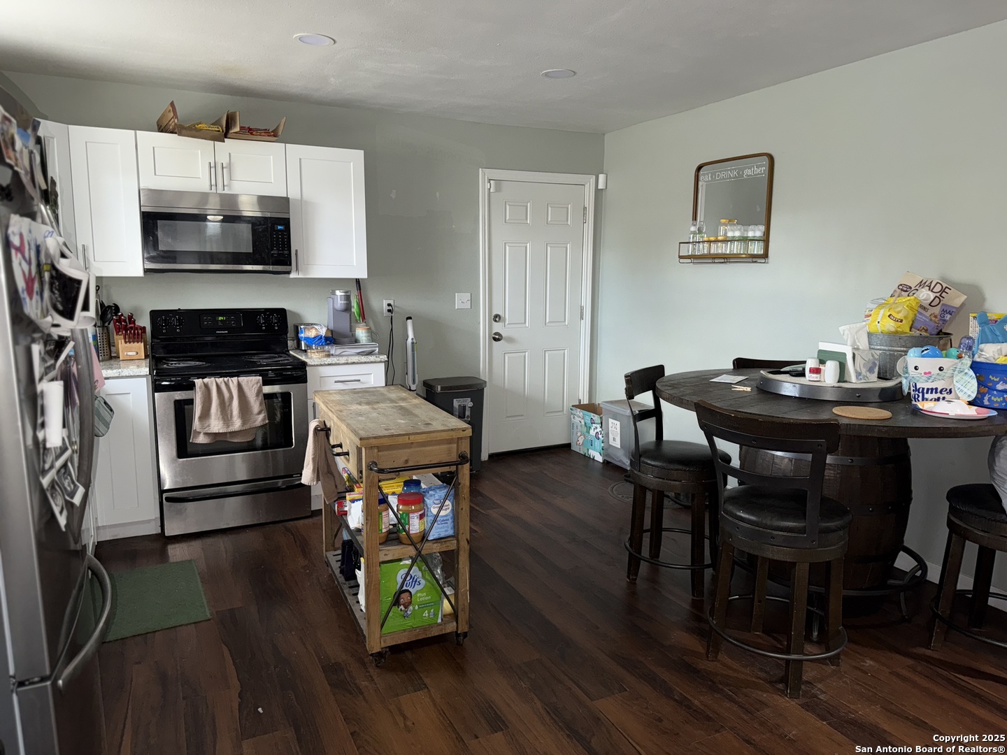 433 West Adams Street Pleasanton, TX 78064 - Photo 5 of 13 a living room with fireplace furniture and a wooden floor