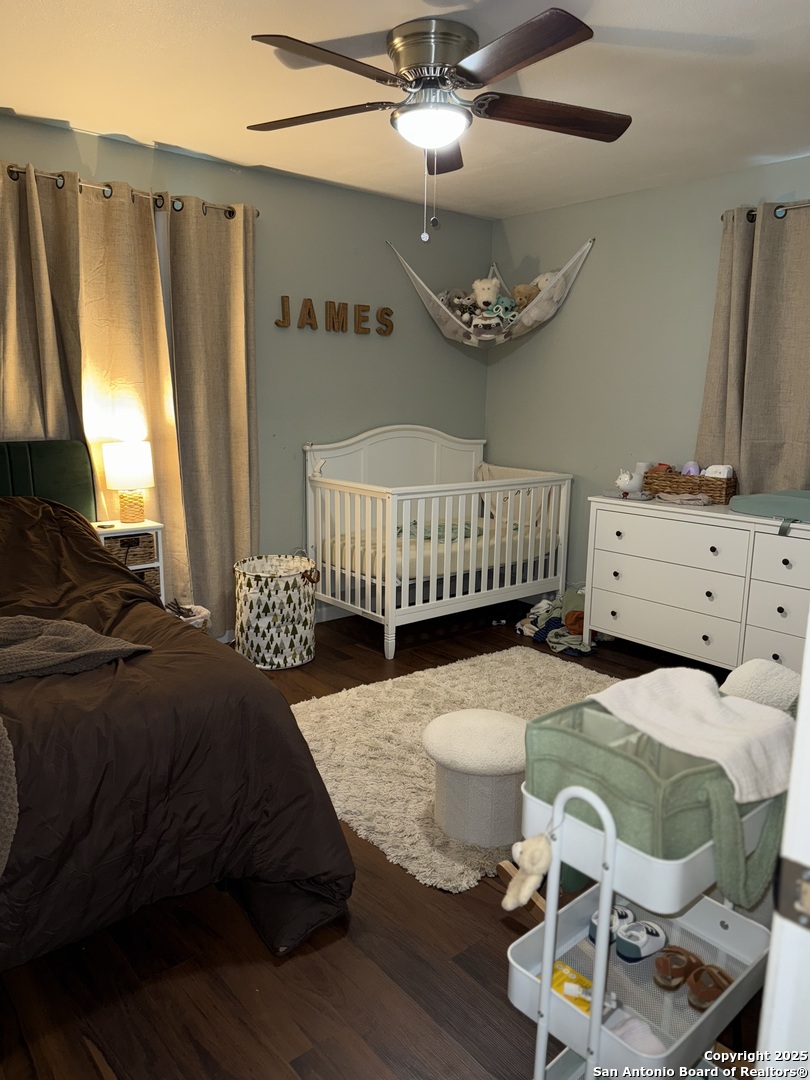 433 West Adams Street Pleasanton, TX 78064 - Photo 7 of 13 a bedroom with a bed and wooden floor