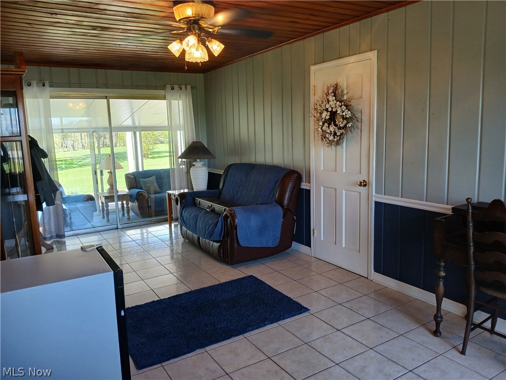 13872 Patch Road Burton, OH 44021 - Photo 22 of 33 Media room has ceramic floor tile and is tastefully decorated and opens to 3-season room