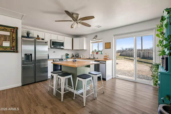 a bedroom with a bed and a potted plant on th table