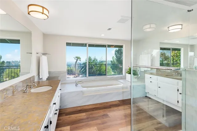 a spacious bathroom with a double vanity sink and a large mirror