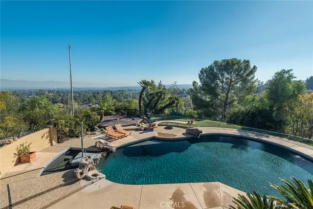 a view of swimming pool and outdoor seating