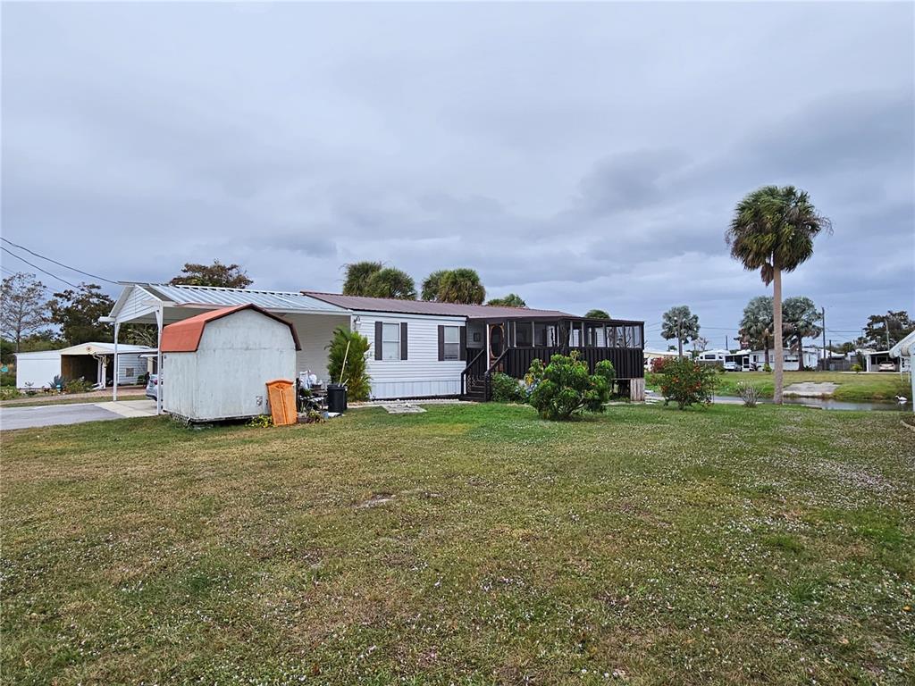 a view of a house with a yard and sitting area