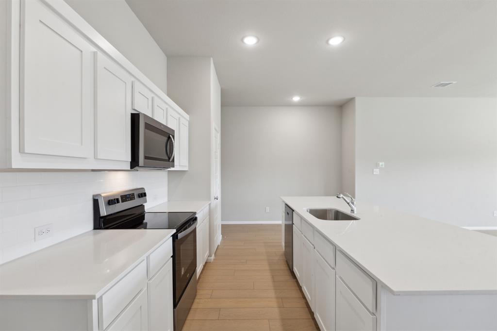 1915 Callington Way Forney, TX 75126 - Photo 7 of 24 Kitchen in the Diamond home plan by Trophy Signature Homes – REPRESENTATIVE PHOTO