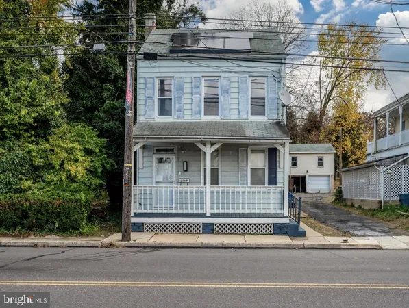 a view of a brick house with large windows and a small yard