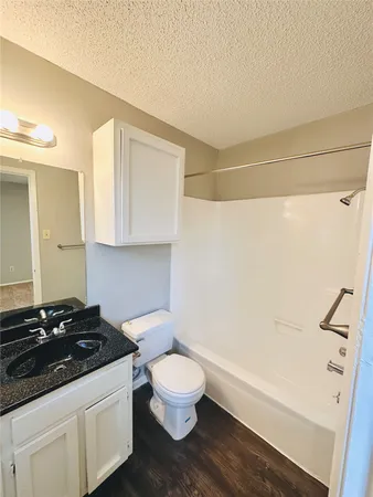 a bathroom with a sink a toilet and a shower