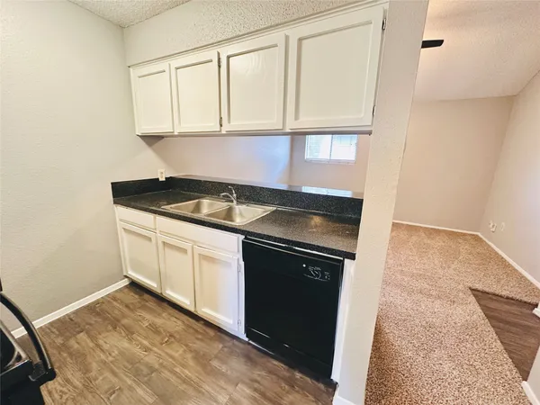 a kitchen with granite countertop white cabinets and a granite counter tops
