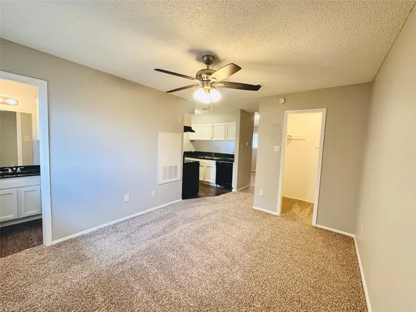 a view of a big room with chandelier fan and a fireplace