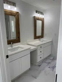 a bathroom with a double vanity sink and mirror