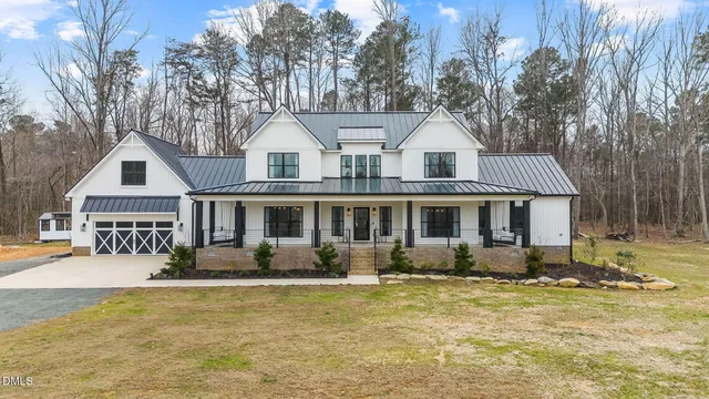 a front view of a residential apartment building with a yard