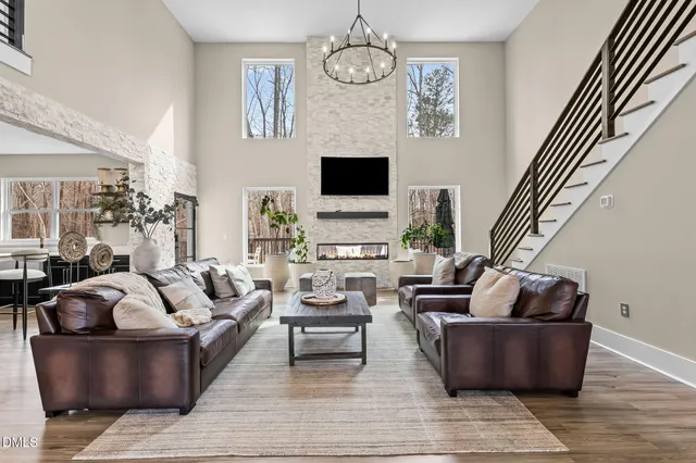 a kitchen with stainless steel appliances granite countertop a sink a stove and a wooden floors