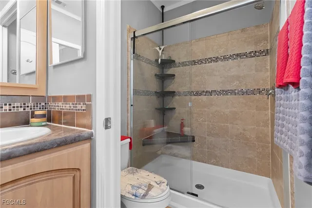 a bathroom with a granite countertop bathtub shower sink and vanity
