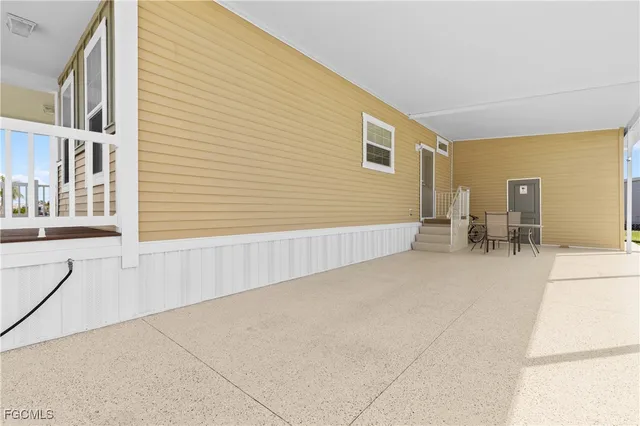 a view of a patio with table and chairs and potted plants