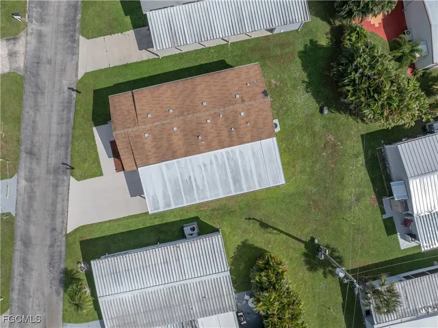 an aerial view of multiple houses with a yard